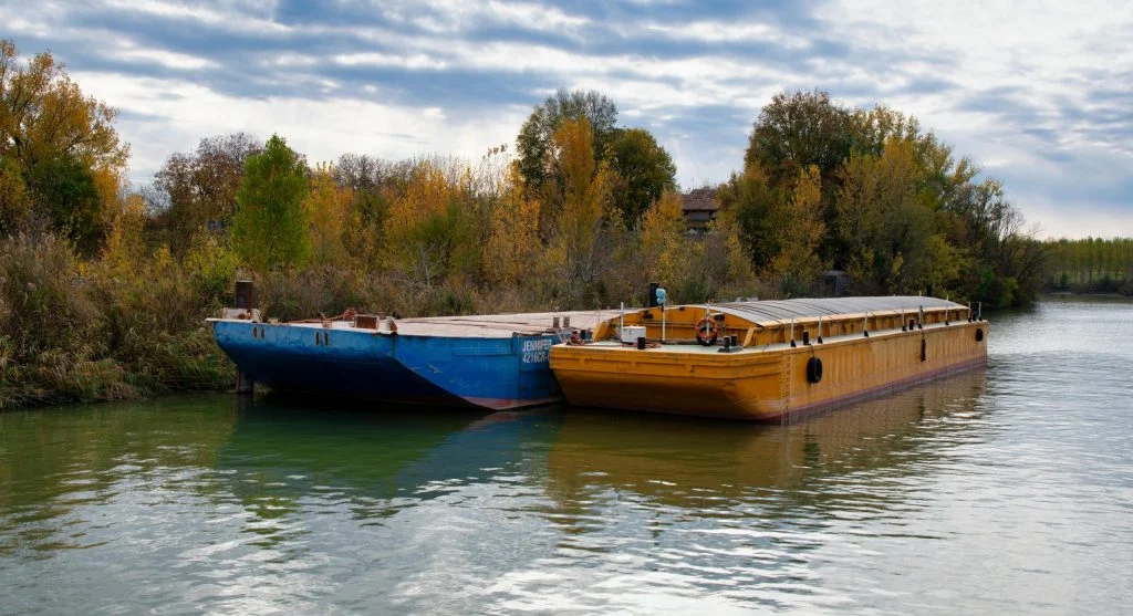 Luxury barge cruise on a European river during autumn