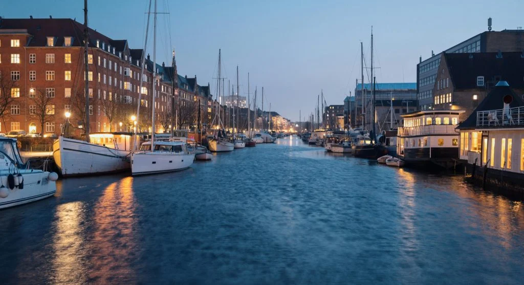 Colorful waterfront lighting at night during a canal tour