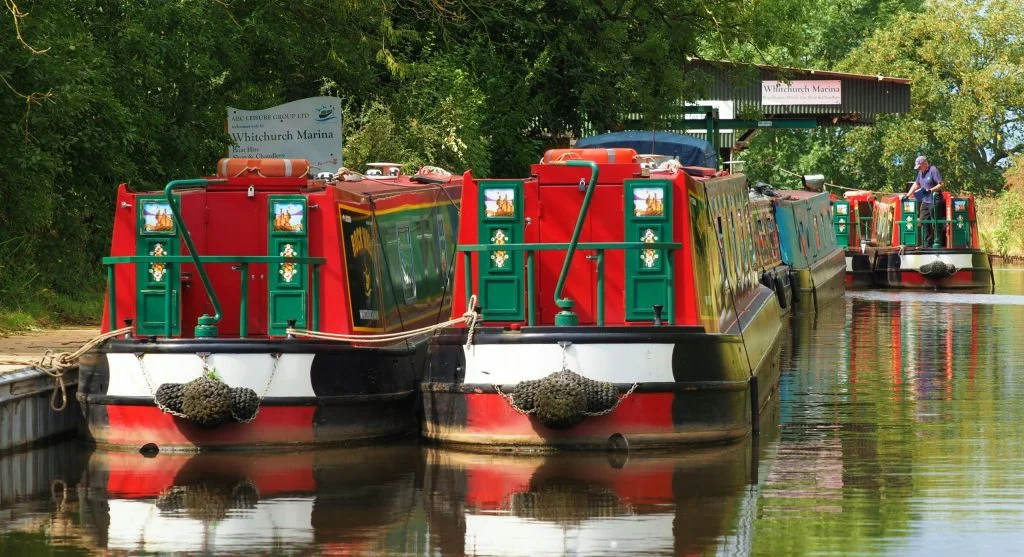 Luxury boat cruising along a peaceful English canal