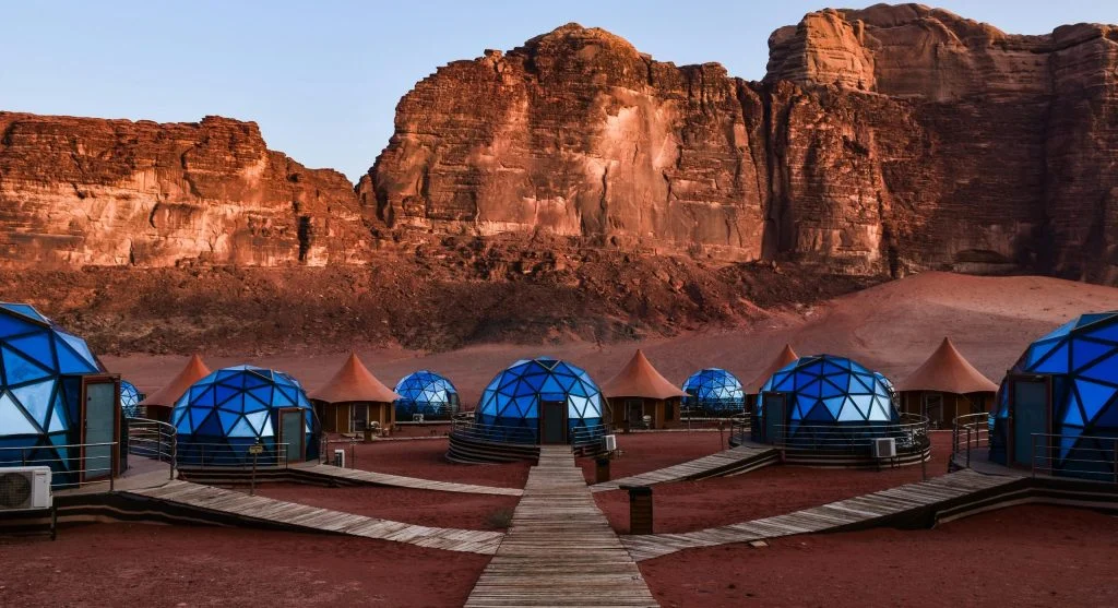 People gazing at stars in a remote camp during luxury outdoor travel