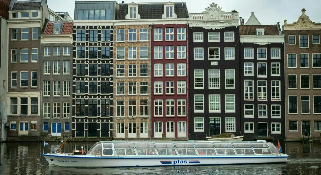 Colorful Dutch canal town with luxury boats and historic architecture