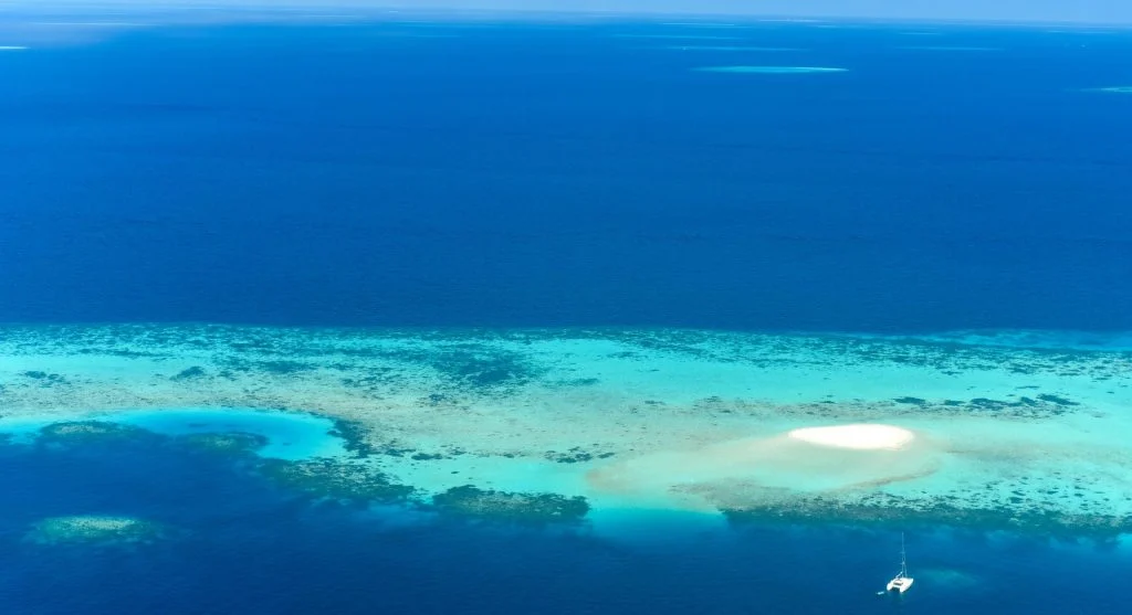 Crystal clear waters and powdery white sand beaches on a luxury island-hopping vacation