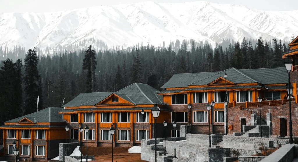 Aerial view of luxury mountain resort surrounded by snow-capped peaks