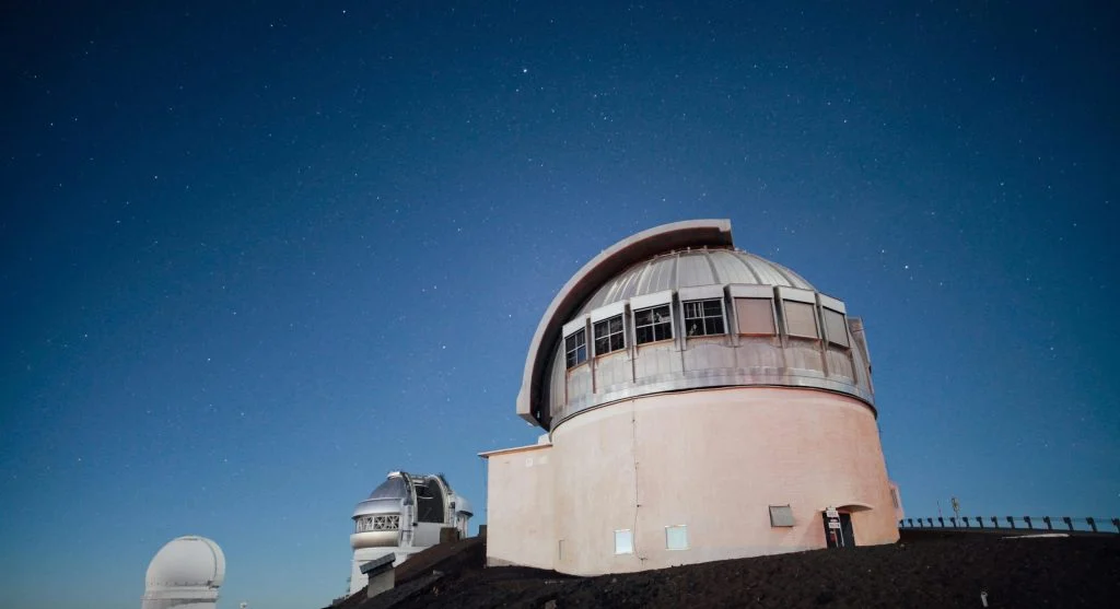 Night sky view from a glass dome resort in the wilderness
