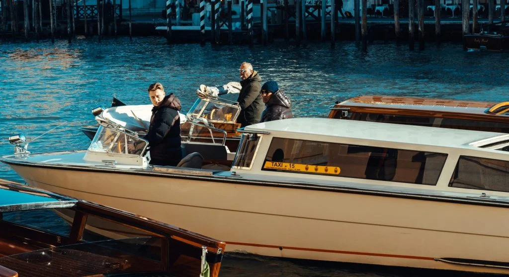 A suitcase packed with elegant clothing and travel accessories for a high-end canal boat trip