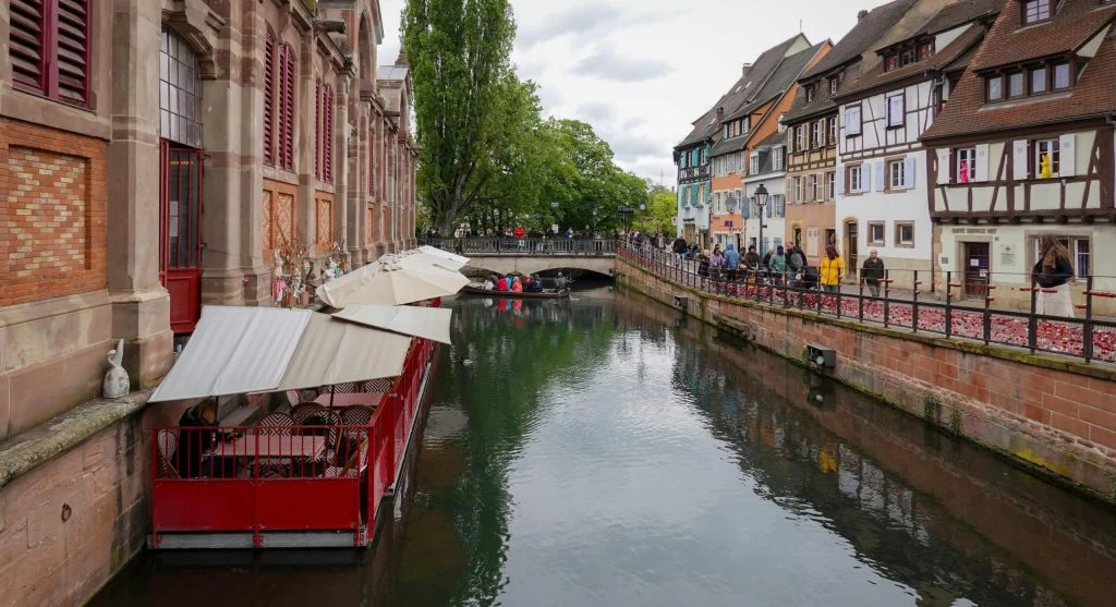 People dining at a restaurant along a historic canal
