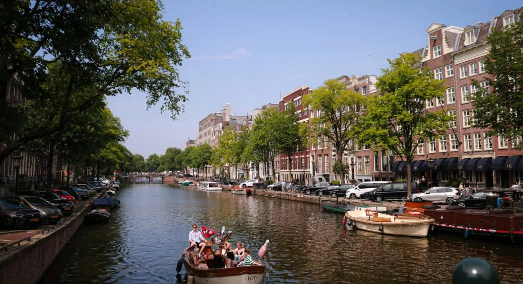 Scenic canal walkway with luxury hotels and family-friendly activities