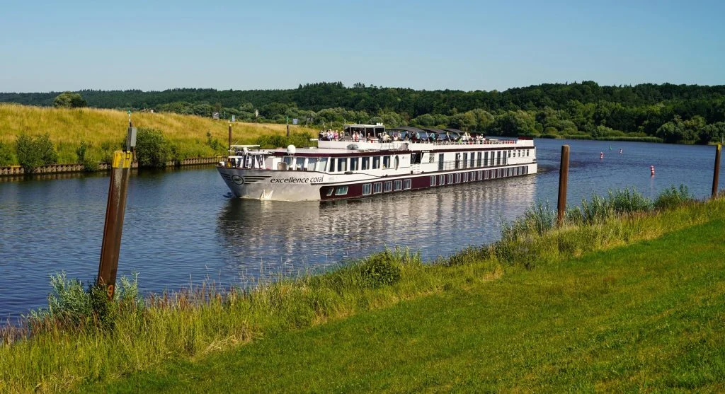 Suitcase packed with elegant clothing and accessories for a high-end canal cruise