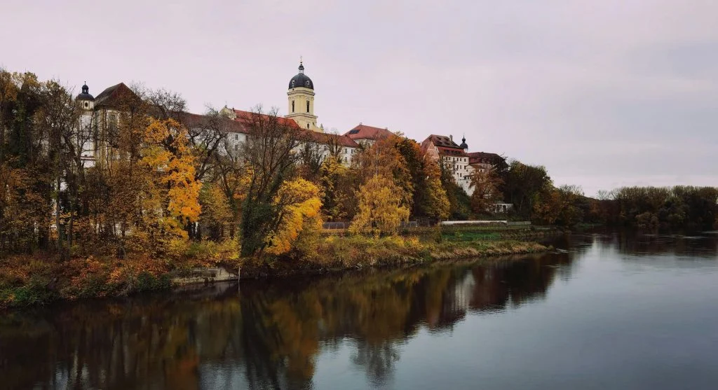Scenic autumn river cruise beside historic towns