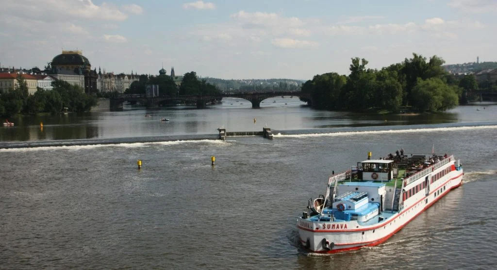 River cruise ship sailing through a historic city