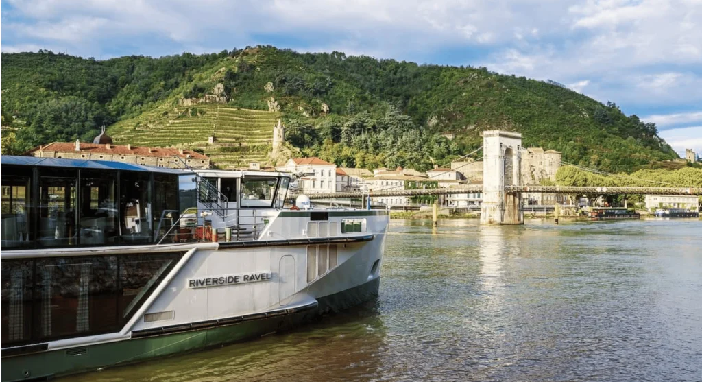 Luxury river cruise ship sailing through historic city