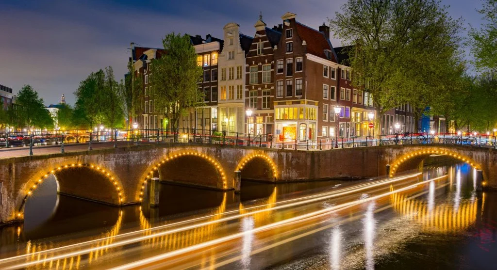 Luxury travel at night beside illuminated canals
