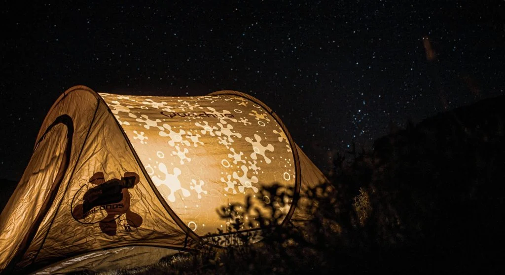Luxury glamping tents under starry night sky