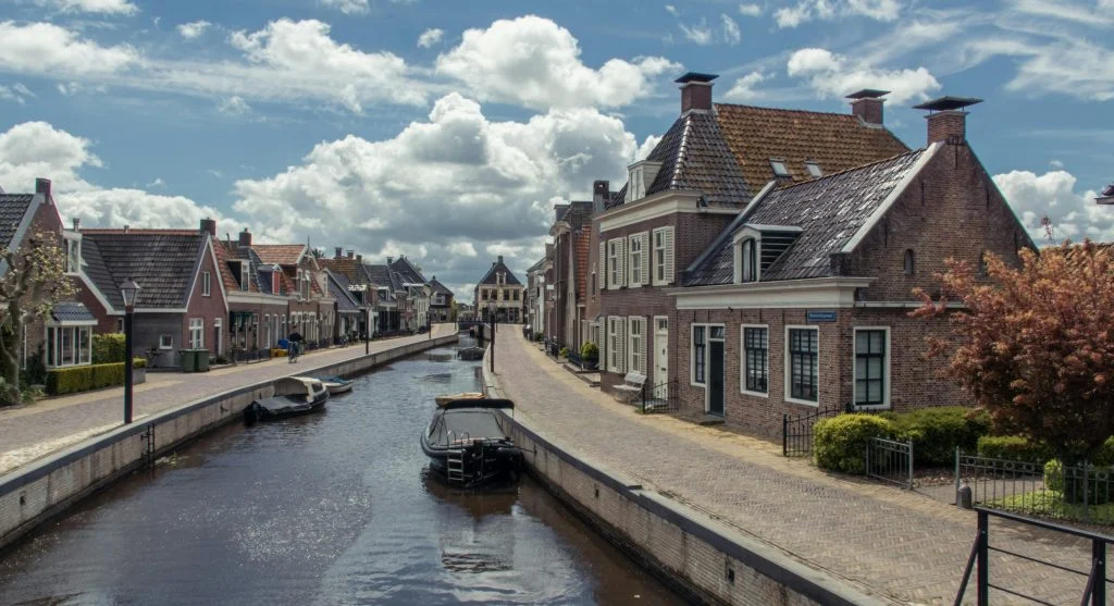 Travelers walking through a quaint village during a luxury canal boat trip
