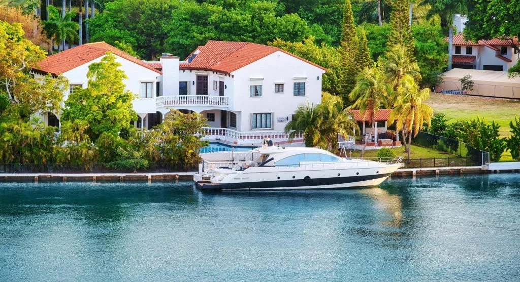 Serene countryside canal with luxury boats and lush green surroundings